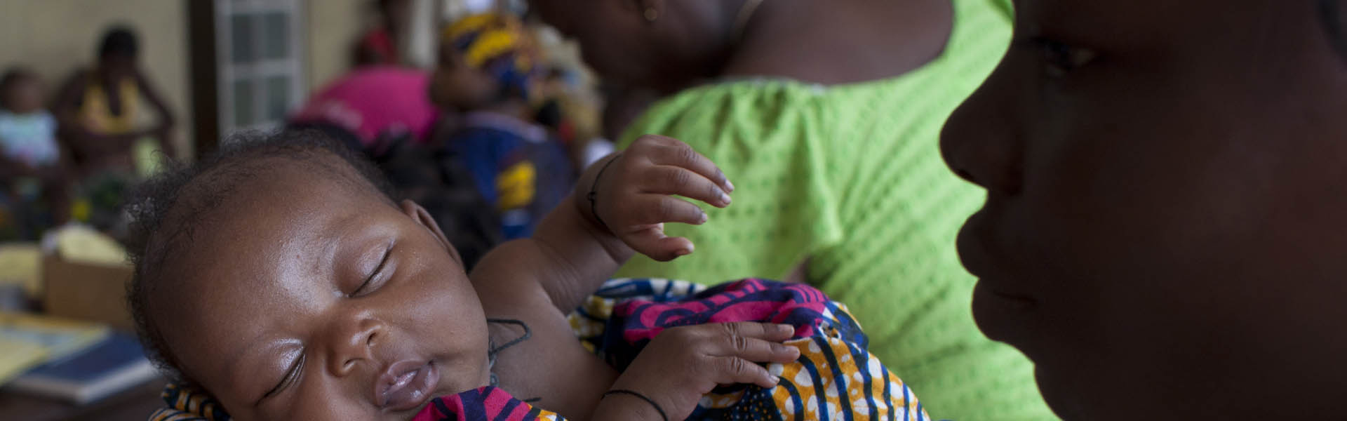 Young woman holding infant.